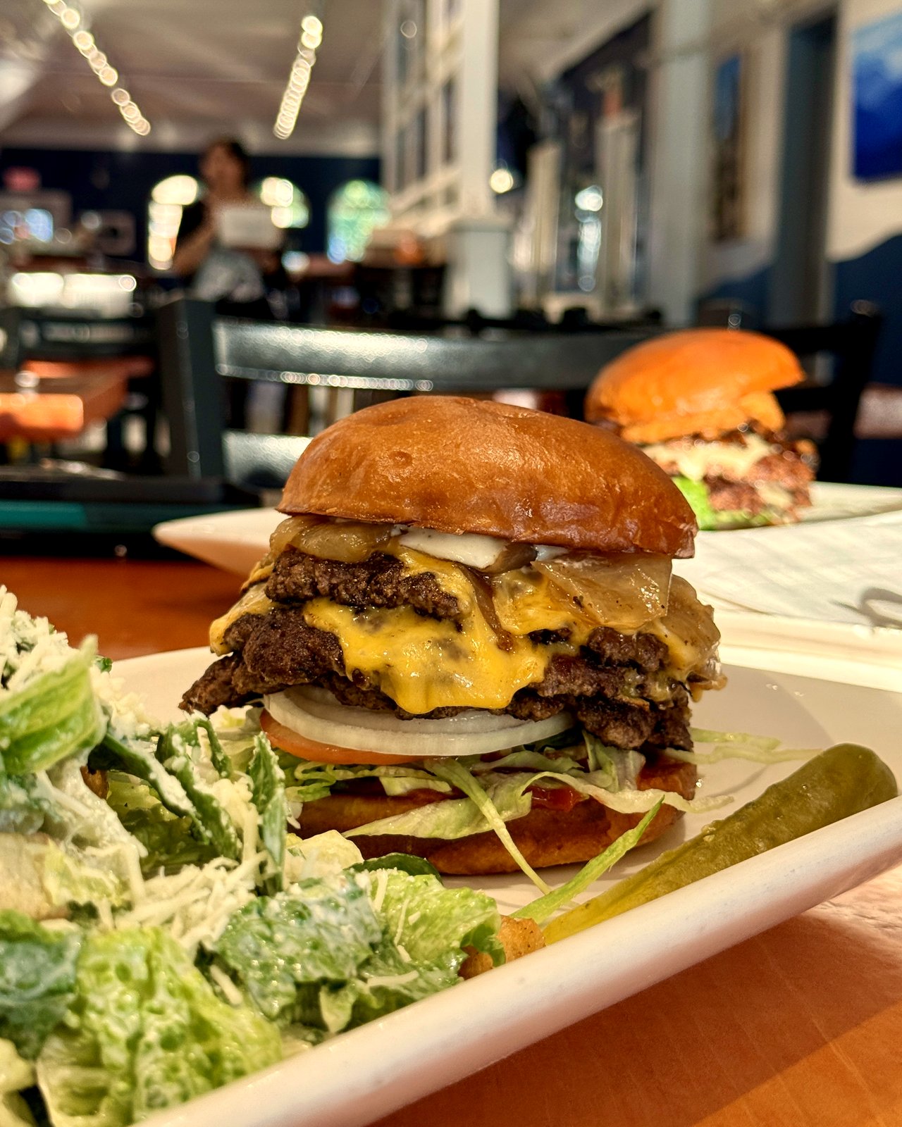 Double OV Cheeseburger with smashed beef patties and caesar salad, OV Burger Bar Prince Rupert