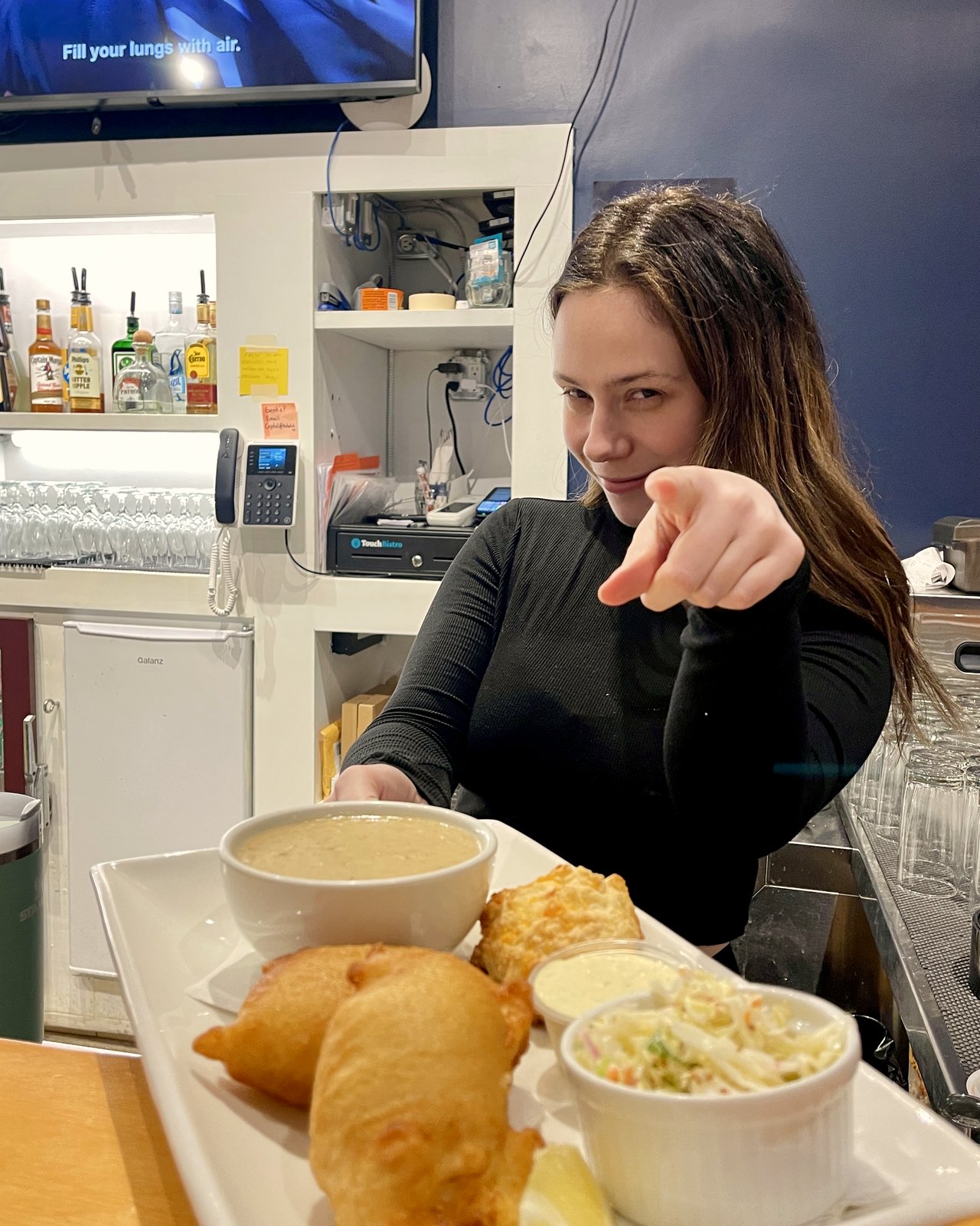 OV Burger Bar bartender Morgan serving Bonnie's fish chowder and homemade pakoras at the bar, OV Burger Bar Prince Rupert