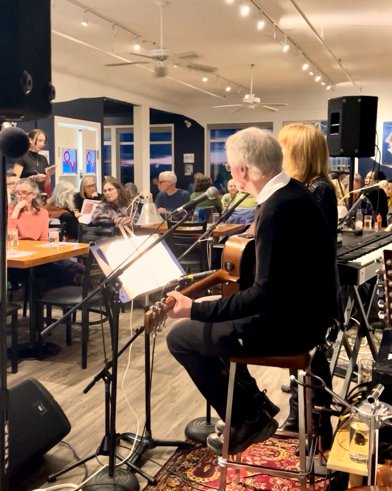 An acoustic duo performing for a full listening room on a live music night at OV Burger Bar in Prince Rupert, BC