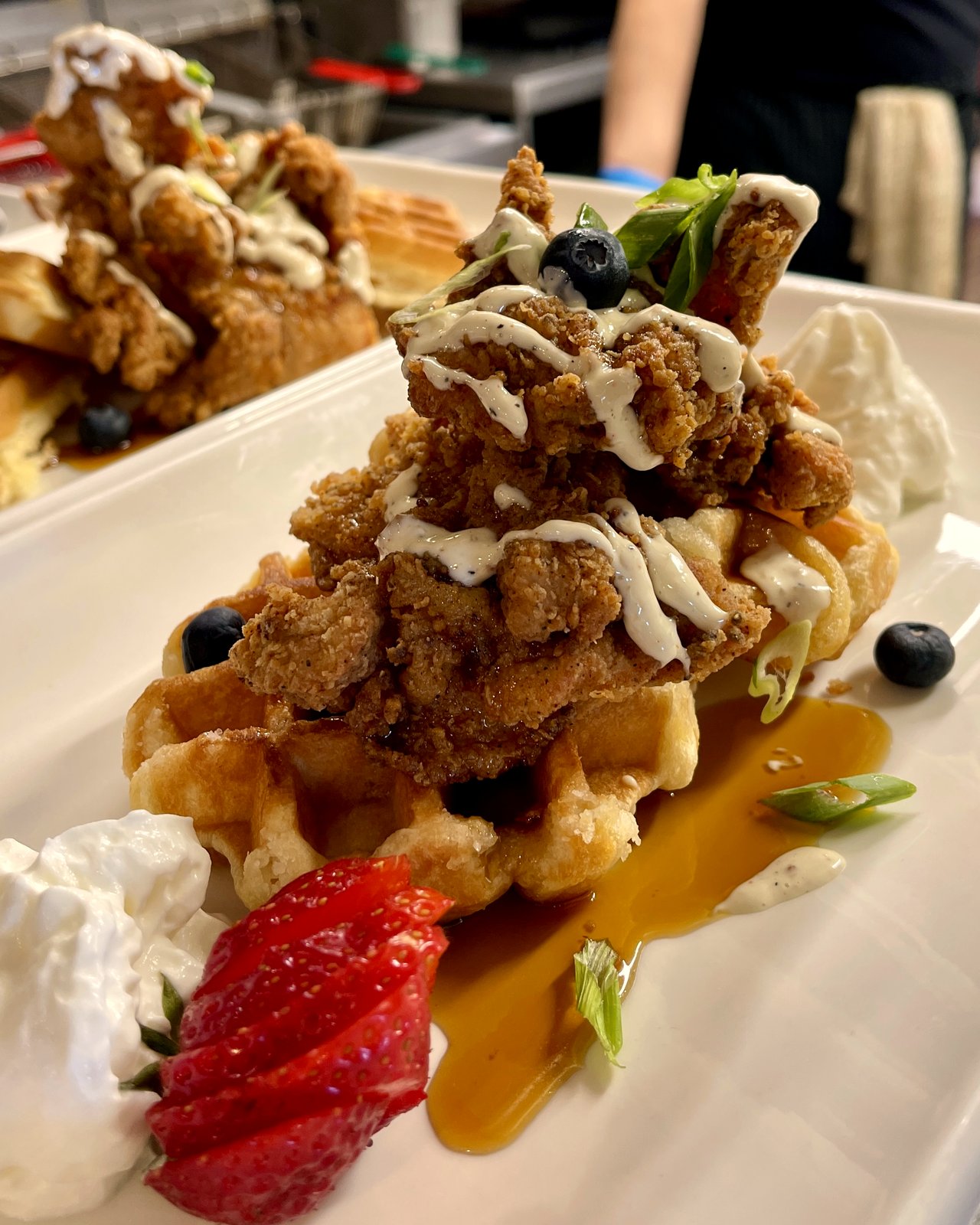 Sunday chicken and waffles with maple syrup, blueberries, strawberries, and ranch drizzle at OV Burger Bar in Prince Rupert, BC